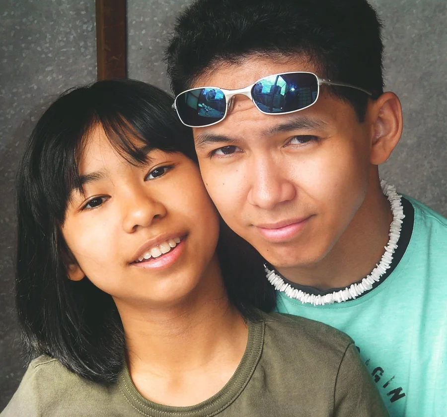My brother with sunglasses resting on his head, beside me.