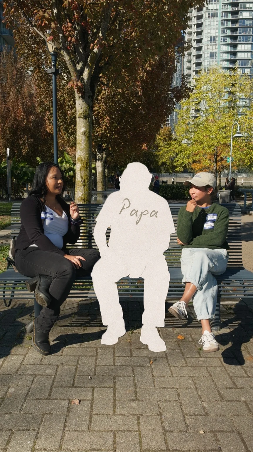 Papa’s white silhouette in a conversation on a park bench.
